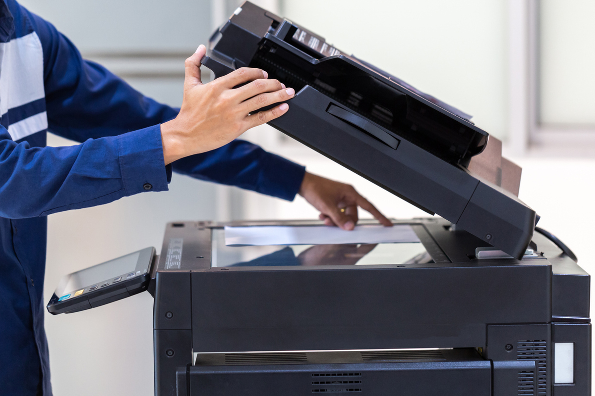 businessman press button on panel of printer photocopier network , working on photocopies in the office concept , printer is office worker tool equipment for scanning and copy paper.
